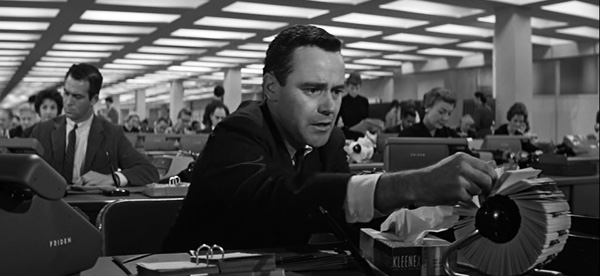 Jack Lemmon at his desk in a massive open office in THE APARTMENT